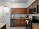 Modern kitchen with granite countertops and stainless steel appliances at 12539 Floridays Resort Dr # 305-D, Orlando, FL 32821