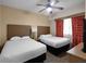 Spacious bedroom with two double beds and ceiling fan at 12539 Floridays Resort Dr # 305-D, Orlando, FL 32821