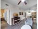 Open living area with hardwood floors and views into other rooms and kitchen at 12539 Floridays Resort Dr # 305-D, Orlando, FL 32821