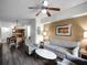 Spacious living room with hardwood floors and views into kitchen and dining area at 12539 Floridays Resort Dr # 305-D, Orlando, FL 32821