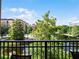 Balcony view overlooking the lake, pool, and lush landscaping at 12539 Floridays Resort Dr # 305-D, Orlando, FL 32821