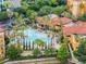 Resort-style pool with lounge chairs and palm trees at 12539 Floridays Resort Dr # 305-D, Orlando, FL 32821