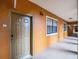 Building hallway with a tan wall and a brown door at 12539 Floridays Resort Dr # 305-D, Orlando, FL 32821