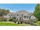 Two-story house with a beige exterior, gray roof, and landscaping at 9502 Hempel Cove Blvd, Windermere, FL 34786