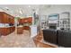 Kitchen with island, wood cabinets, and tile flooring. Open to living area at 9502 Hempel Cove Blvd, Windermere, FL 34786