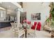 Breakfast nook with glass top table, red couch and white chairs, and large windows at 9502 Hempel Cove Blvd, Windermere, FL 34786