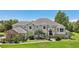 Two-story house with a beige exterior, gray roof, and landscaping at 9502 Hempel Cove Blvd, Windermere, FL 34786