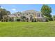 Two-story house with a beige exterior, gray roof, and landscaping at 9502 Hempel Cove Blvd, Windermere, FL 34786