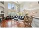 Spacious living room with hardwood floors, large windows, and a cozy seating area at 9502 Hempel Cove Blvd, Windermere, FL 34786