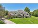 Two-story house with a beige exterior, gray roof, and landscaping, driveway at 9502 Hempel Cove Blvd, Windermere, FL 34786