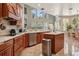 Bright kitchen featuring an island, wood cabinets, and granite countertops at 9502 Hempel Cove Blvd, Windermere, FL 34786