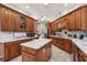 Large kitchen with an island, wood cabinets, and tile flooring at 9502 Hempel Cove Blvd, Windermere, FL 34786