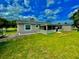 Home exterior showcasing a large backyard and screened patio at 705 Harland Ct, Kissimmee, FL 34758