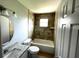 Clean bathroom with tile surround and granite countertop at 705 Harland Ct, Kissimmee, FL 34758