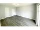 Bright bedroom featuring wood-look flooring and an exterior door at 705 Harland Ct, Kissimmee, FL 34758