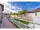 Artificial turf backyard with patio and white picket fence at 2518 Fontaine Dr, Kissimmee, FL 34741