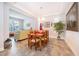 Bright dining area with a wooden table and chairs, adjacent to the living room at 2518 Fontaine Dr, Kissimmee, FL 34741