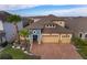 Two-story house with a two-car garage and a landscaped yard at 2518 Fontaine Dr, Kissimmee, FL 34741