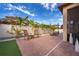 Landscaped backyard with patio, seating, and artificial turf at 2518 Fontaine Dr, Kissimmee, FL 34741