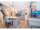 Open concept kitchen with island, stainless steel appliances, and staircase view at 2518 Fontaine Dr, Kissimmee, FL 34741
