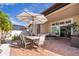 Brick patio with outdoor dining set, hammock, and umbrella at 2518 Fontaine Dr, Kissimmee, FL 34741