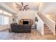 Open living room with a high ceiling, large TV, and staircase at 2518 Fontaine Dr, Kissimmee, FL 34741
