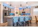 Modern kitchen with an island, stainless steel appliances, and blue-patterned barstools at 2518 Fontaine Dr, Kissimmee, FL 34741