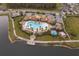 Aerial view of resort-style community pool with expansive deck and lakefront access at 2518 Fontaine Dr, Kissimmee, FL 34741
