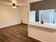 Living room with dark vinyl flooring and a view of the kitchen at 414 Banana Cay Dr # I, South Daytona, FL 32119