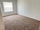 Bright bedroom with carpeted floors and window with blinds at 414 Banana Cay Dr # I, South Daytona, FL 32119