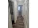 Hallway with wood-look flooring and access to bathroom at 414 Banana Cay Dr # I, South Daytona, FL 32119