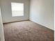 Well-lit bedroom with neutral carpeting and large window at 414 Banana Cay Dr # I, South Daytona, FL 32119