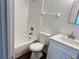 Updated bathroom with a white vanity, tub, and shower at 414 Banana Cay Dr # I, South Daytona, FL 32119