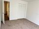 Spacious bedroom with neutral carpeting and a large closet at 414 Banana Cay Dr # I, South Daytona, FL 32119