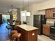 Open kitchen with island and stainless steel appliances at 12539 Floridays Resort Dr # 104 D, Orlando, FL 32821