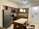 Modern kitchen with island and granite countertops at 12539 Floridays Resort Dr # 104 D, Orlando, FL 32821