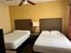 Two twin beds with neutral decor in bright bedroom at 12539 Floridays Resort Dr # 104 D, Orlando, FL 32821