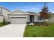 One-story home with two-car garage and landscaping at 154 Bull Frog Ln, Umatilla, FL 32784