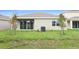 Landscaped backyard with grassy lawn at 154 Bull Frog Ln, Umatilla, FL 32784