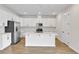 Modern kitchen with island, white cabinets, and stainless steel appliances at 154 Bull Frog Ln, Umatilla, FL 32784