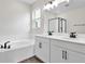 Elegant bathroom with double vanity, soaking tub, and shower at 154 Bull Frog Ln, Umatilla, FL 32784