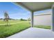 Covered patio overlooking a grassy backyard at 154 Bull Frog Ln, Umatilla, FL 32784
