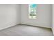 Bright bedroom with carpeted floors and a large window at 154 Bull Frog Ln, Umatilla, FL 32784