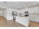 Modern kitchen with white cabinets, island, and stainless steel appliances at 154 Bull Frog Ln, Umatilla, FL 32784