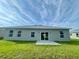 Rear view of house showing sliding glass doors leading to patio at 274 Elm Ct, Kissimmee, FL 34759