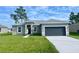 New construction home with gray exterior, two-car garage, and landscaped lawn at 274 Elm Ct, Kissimmee, FL 34759