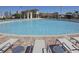 Large resort-style pool with lounge chairs and a clubhouse view at 8919 Stinger Dr, Davenport, FL 33896