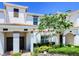 Front view of two-story townhome with landscaping at 8919 Stinger Dr, Davenport, FL 33896