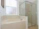 Bathroom with soaking tub and shower at 573 Viola Dr, Davenport, FL 33837