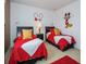 Mickey Mouse-themed bedroom with two twin beds at 573 Viola Dr, Davenport, FL 33837